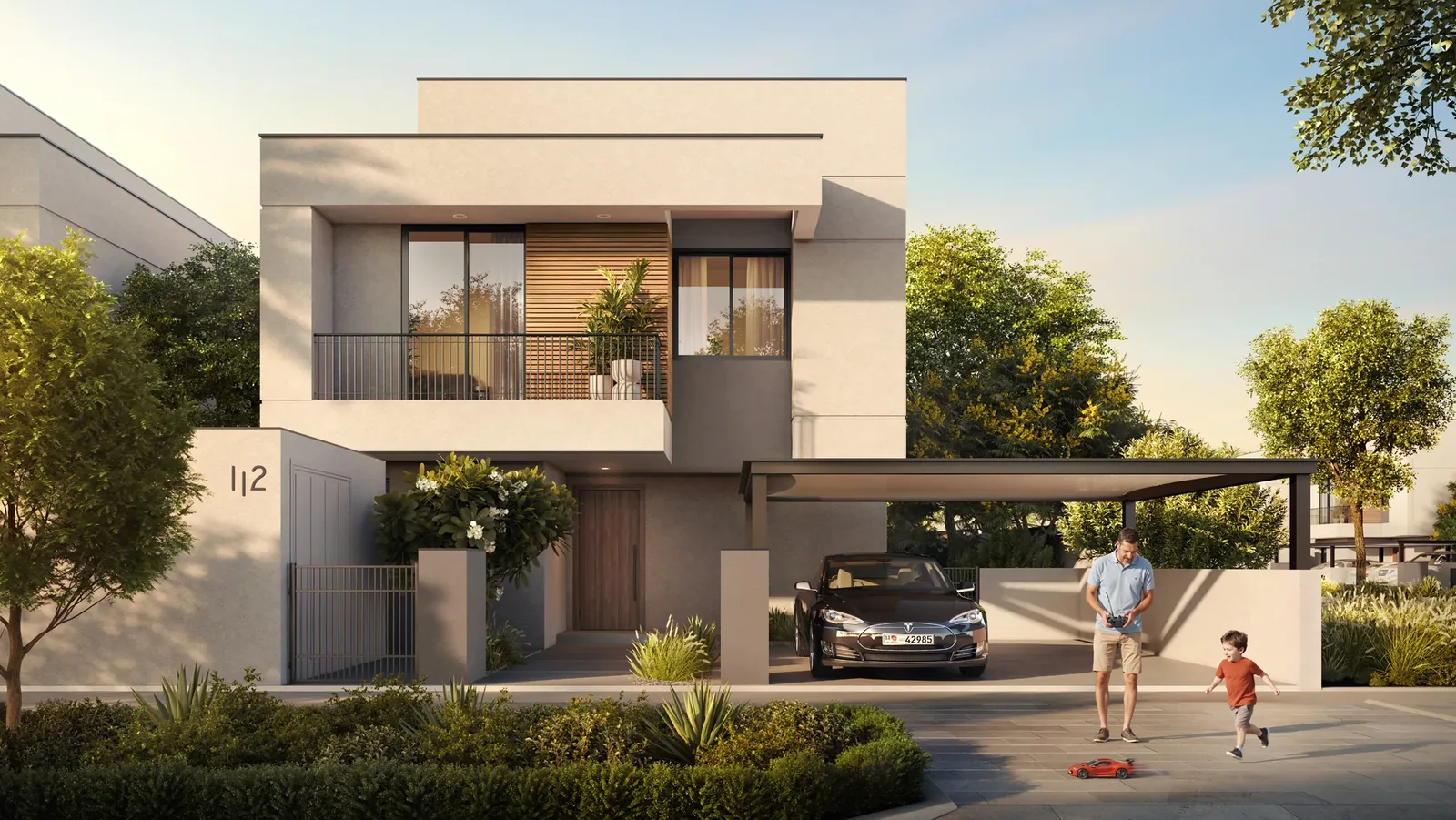 Al Ghadeer Gardens Review: Worth Buying in 2026? Family outside a villa at Al Ghadeer Gardens
